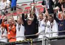 Trophy time - Bromley boss Andy Woodman celebrates with the play-off trophy following their penalty shoot-out win over Solihull Moors