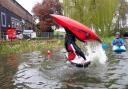 Flip - A canoer shows his skills, backflipping on the water.