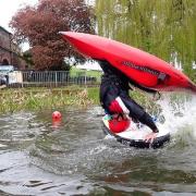 Flip - A canoer shows his skills, backflipping on the water.