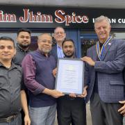 Award - Stanway's Rim Jhim Spice's Restaurant Team pictured with Rotary Club president Peter Rutland (second from right)