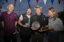 Prize time - Paul Birthnell (left), from sponsor Marinestore Chandlery, presents the Golly Gamble Trophy to Tom Bowman, Ifor Bielecki and Lucy Bowman. The trio won the Mersea Fishermen’s Open Boat event on board Mystery Picture: CHRISSIE WESTGATE