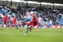 Challenge - Colchester United striker John Akinde looks to win the ball against Walsall