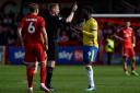 Dismissal - Colchester United striker Samson Tovide is shown a red card by referee Scott Oldham in the closing stages of their game at Crawley Town