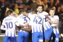 Big moment - Colchester United's players celebrate John Akinde's goal against Grimsby Town