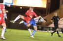 Balancing act - Colchester United goalscorer Tom Hopper battles for the ball during his side's win over Grimsby Town