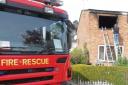 Gutted – a fire investigator checks out the damaged house in New Kiln Road, Colchester