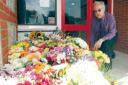 Overwhelmed - headteacher John Watts with floral tributes to Daniel Mullinger, outside Heathlands Primary School in West Bergholt. Picture: STEVE BRADING (56603-b)