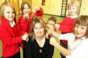 Hair-raising - teacher Carolyn Edwards prepares for her new hairstyle with Relay Crabb, 4, Alice Mellor, 9, Tiana Edwards, 7, Georgia Luckey, 9, and Dominic Luckey, 9. Picture: STEVE BRADING (59676-a)