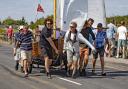 Team work - a Clinker dinghy sporting the Mersea Week Pennant is tugged across the Strood Pictures: CHRISSIE WESTGATE