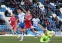 Cool finish - Tom Hopper lifts the ball past Grimsby Town goalkeeper Jake Eastwood to score for Colchester United
