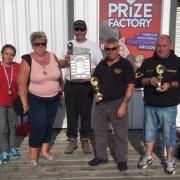 PRIZE TIME: the Clacton Pier charity match winners proudly display their medals and trophies after a blistering day of fishing.