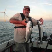 JW 02 Aug 2020 angling john popplewell angling Alan Tipple with a brace of bass from the Gunfleet Sands