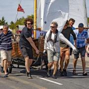 Team work - a Clinker dinghy sporting the Mersea Week Pennant is tugged across the Strood Pictures: CHRISSIE WESTGATE