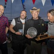 Prize time - Paul Birthnell (left), from sponsor Marinestore Chandlery, presents the Golly Gamble Trophy to Tom Bowman, Ifor Bielecki and Lucy Bowman. The trio won the Mersea Fishermen’s Open Boat event on board Mystery Picture: CHRISSIE WESTGATE
