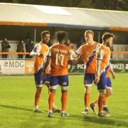 Big win: Shaq Coulthirst celebrates with his Braintree Town team-mates after scoring against Hampton and Richmond.