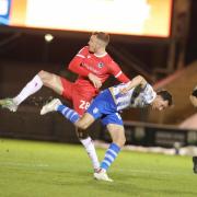 Balancing act - Colchester United goalscorer Tom Hopper battles for the ball during his side's win over Grimsby Town