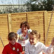 Jessica and Bethany Taylor enjoy the new swing at Lexden Springs School in Colchester