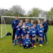 A CREDIT TO THEIR CLUB: Frinton’s girls’ team with coach Ben Pratt (far left) and manager Tom Vousden (far right).
