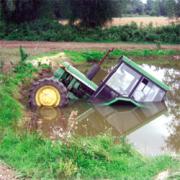 Partly submerged - the John Deere tractor in the pond at Mill Pond farm, Little Oakley, after the mishap involving Gary May. Picture: SUBMITTED