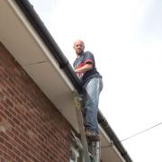 Down safe - Paul Findlay on the ladder at this house. Picture: STEVE ARGENT (79205-1)