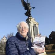 Andrew Phillips with his book about WW1 in Colchester that he is donating the proceeds from To The Royal British Legion, pictured at Colchester War Memorial..