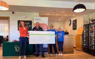 Cheque - Colne Valley Golf Club ladies captain Ruth Eyre-Pugh and men's captain Steve Leak handed the cheque to Cathy Chambers and Ann from the MNDA