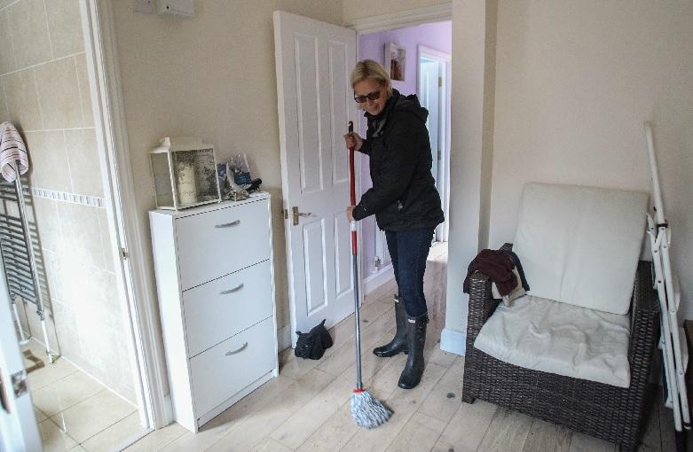 Karen Fox was left sweeping water from her flooded home in Hull House Mews