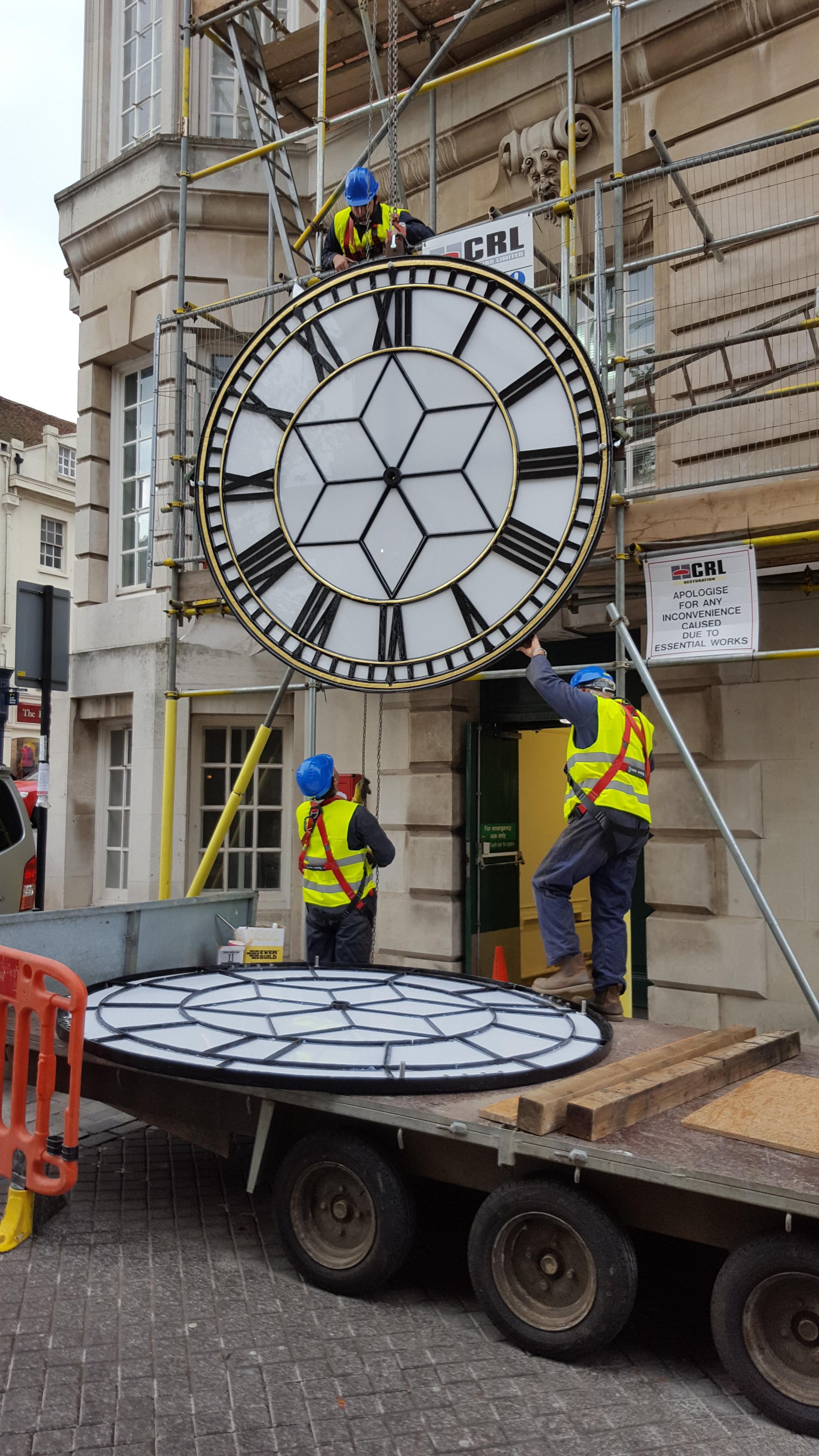 Going up! Town Hall clock gets two new faces in refurb