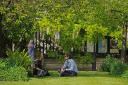 People relax in the warm weather near St Paul’s Cathedral (Yui Mok/PA)