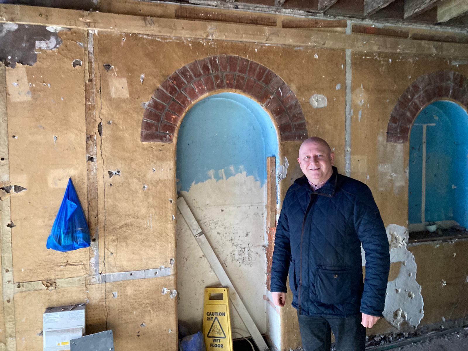 Buddies owner Andy Cheesman in front of one of the hidden doorways uncovered during the refurbishment