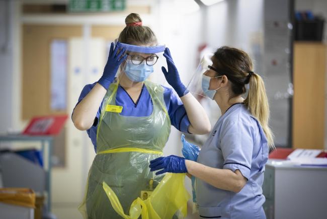 Nurses changing their PPE on Ward 5, a Covid Red Ward, at the Royal Alexandra Hospital in Paisley. Picture date: Wednesday January 27, 2021.