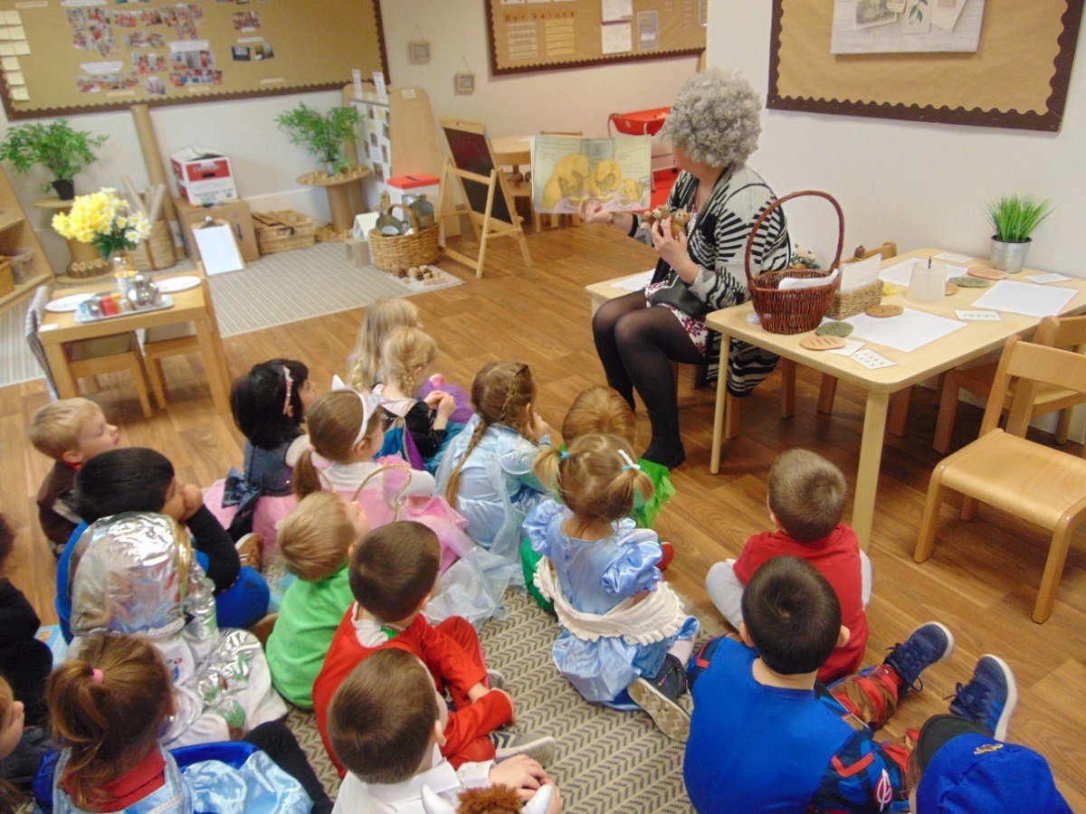 Story telling - early years practitioner Rachel Gwilliam dressed up as Gangsta Granny, from the David Walliams book. She is pictured sharing stories with the Foundation class children at Busy Bees Day Nursery