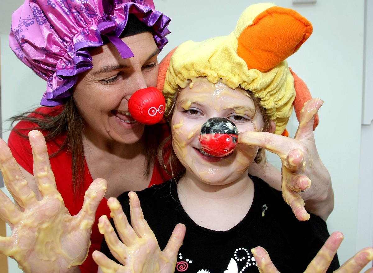 Keen as custard - Jodean Speller and daughter Hannah, then ten, bathed in custard outside their house in Great Notley, in 2011