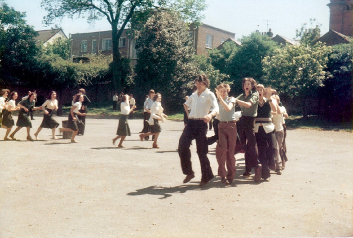 Follow the leader - school leavers on their last day, probably in the 1980s