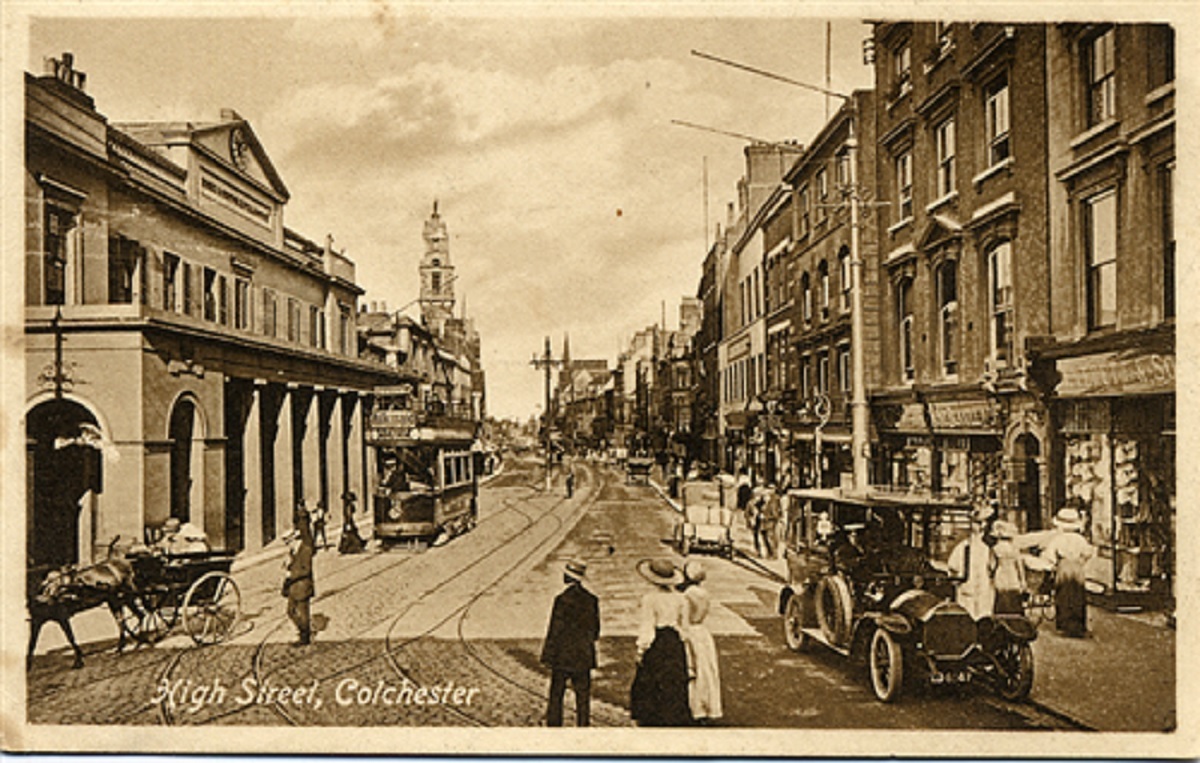 On the move - trams and cars are on show in this black and white photographic postcard of the High Street, taken between 1900 and 1910