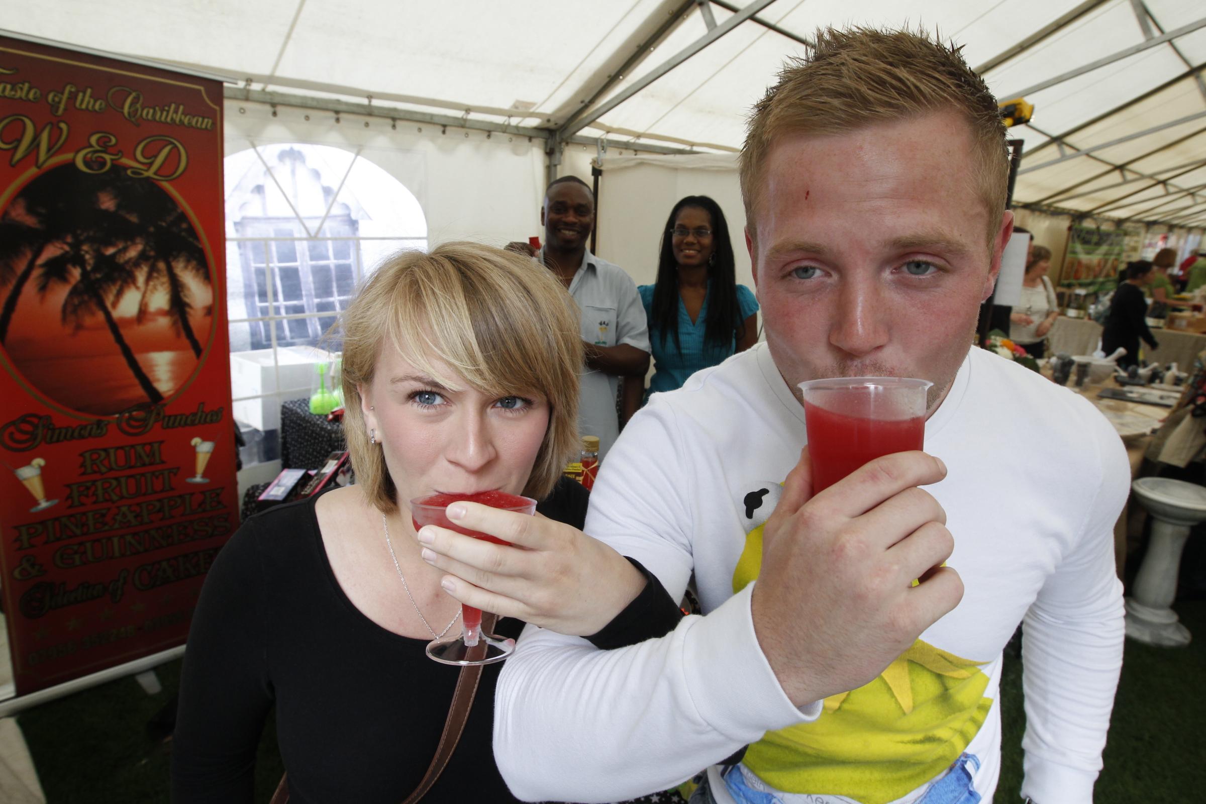 Great minds drink alike - Michael Sargeant and Natalie Hays try a taste of Caribbean punch