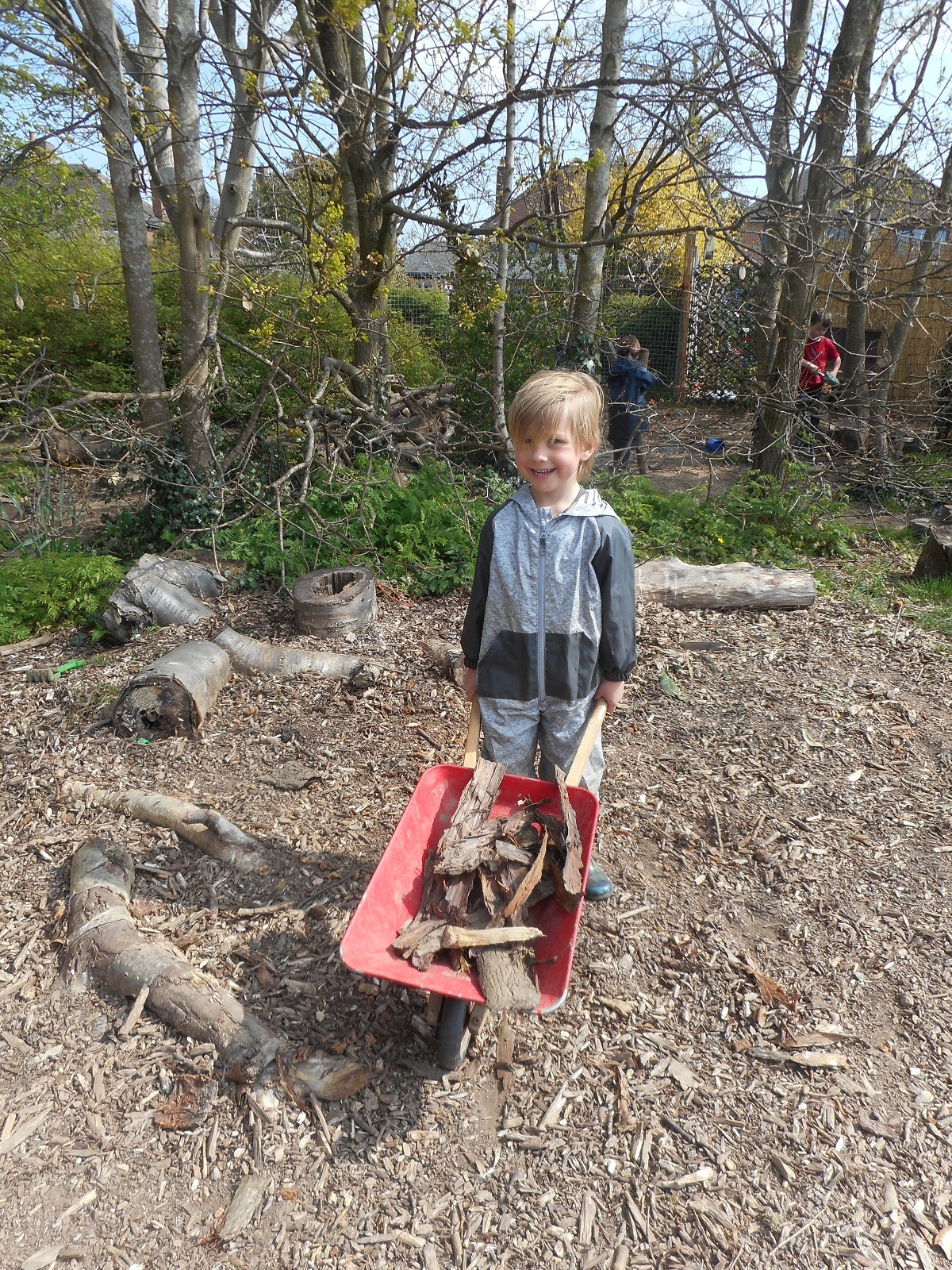 Going places - Ethan Jenner uses a wheelbarrow in the forest school