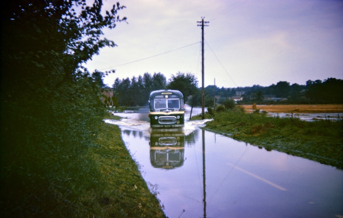 Nothing ventured, nothing rained - a bus driver battles his way through the flooded River Stour at the bottom of Horkesley Hill