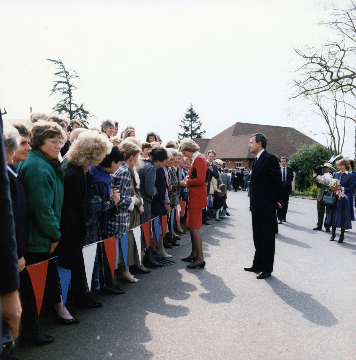 Stopping for a chat - Princess Diana talks to people on the short walk from the day centre to the hospice