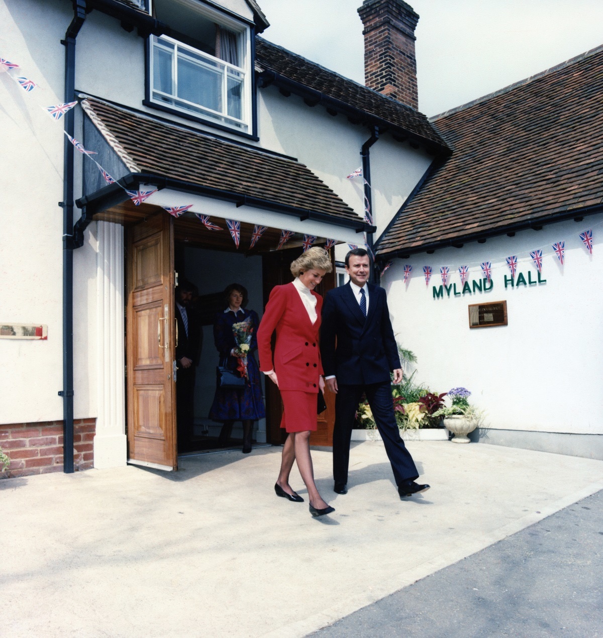 On her way - Princess Diana leaves the hospice after meeting hospice inpatients. She is pictured with chairman Christopher Holmes