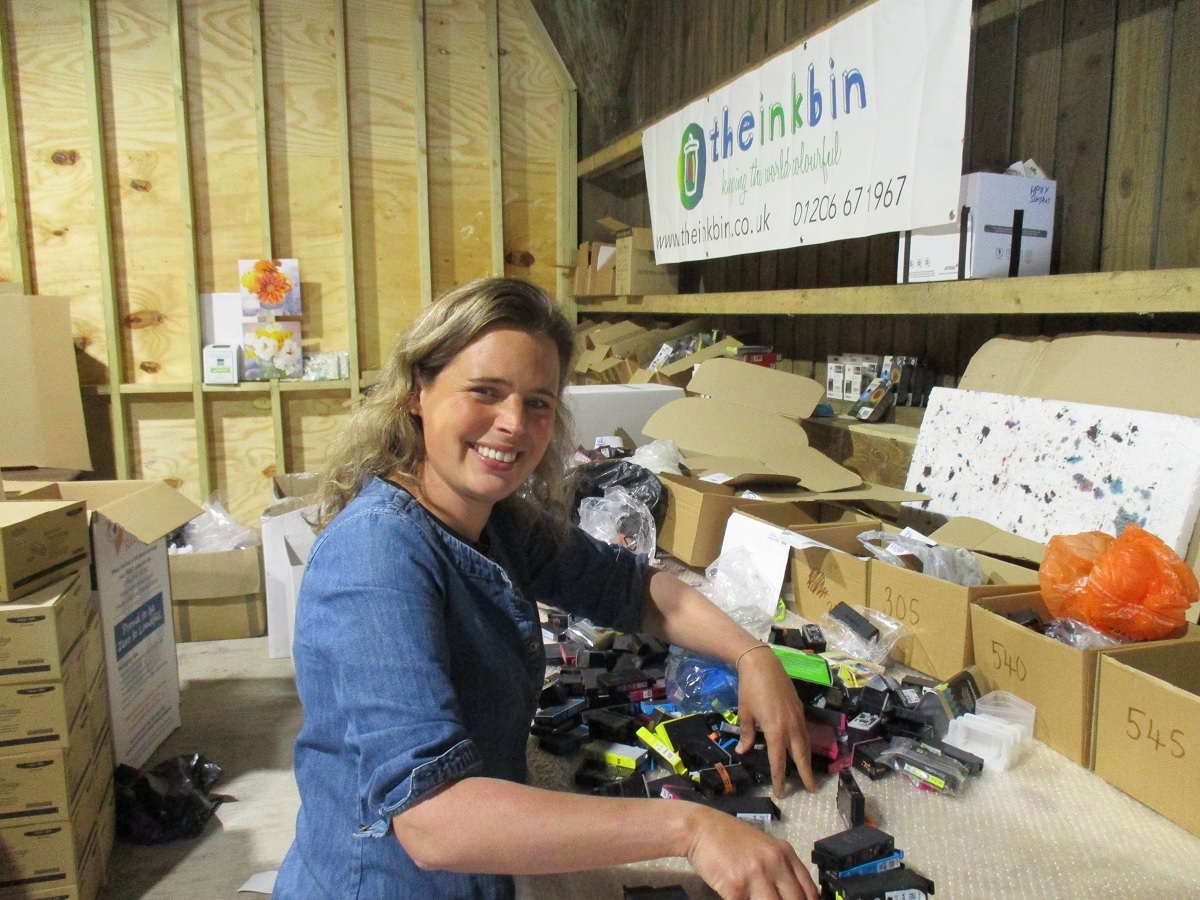 Hard at work - Becky Baines at her workbench, sorting through another batch of empty ink cartridges