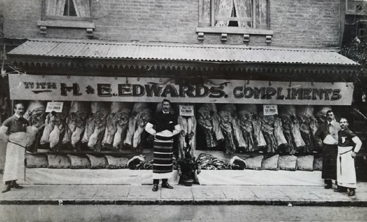 Where it all began - the original H & E Edwards, then a butchers on the corner of Queen Street and Osborne Street. Henry Edwards might be the tall, black-haired gentleman standing in the middle