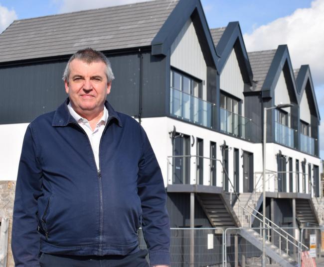VILLAGE REVIVAL: Paul Honeywood, councillor responsible for Housing, pictured outside the finished Jaywick homes 