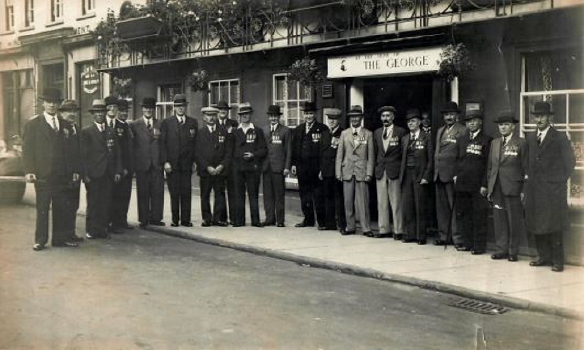 Gathering - this wonderful picture was taken in the 1920s. It shows various gentlemen proudly showing off medals outside The George