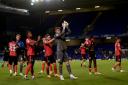 Jubilant - Colchester United players celebrate at the final whistle following their 1-0 win at Ipswich Town in the Carabao Cup Picture: RICHARD BLAXALL