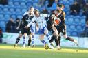 Tussle - Colchester United midfielder Cam McGeehan battles for possession against Barrow