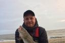 Unlikely catch: Matt Clark with a rare codling, caught from the Holland beaches.