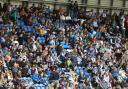 Stand and deliver - Colchester United fans watch their team at the JobServe Community Stadium