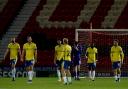 Sinking feeling - Colchester United's players trudge away after conceding the opening goal at Doncaster Rovers