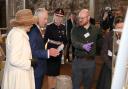 King Charles and Queen Consort Camilla are shown an exhibit at Colchester Castle by curator Glynn Davis